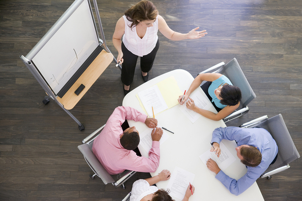 Person presenting to a team.